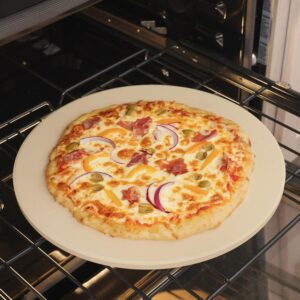Pizza baking on a preheated pizza stone inside a home oven